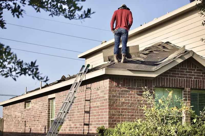 Professional roofer working on a residential roof in Mills River